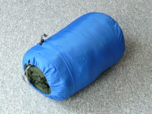 A colorful sleeping bag laid out inside a tent, showcasing its insulation and warmth, perfect for a winter camping trip.