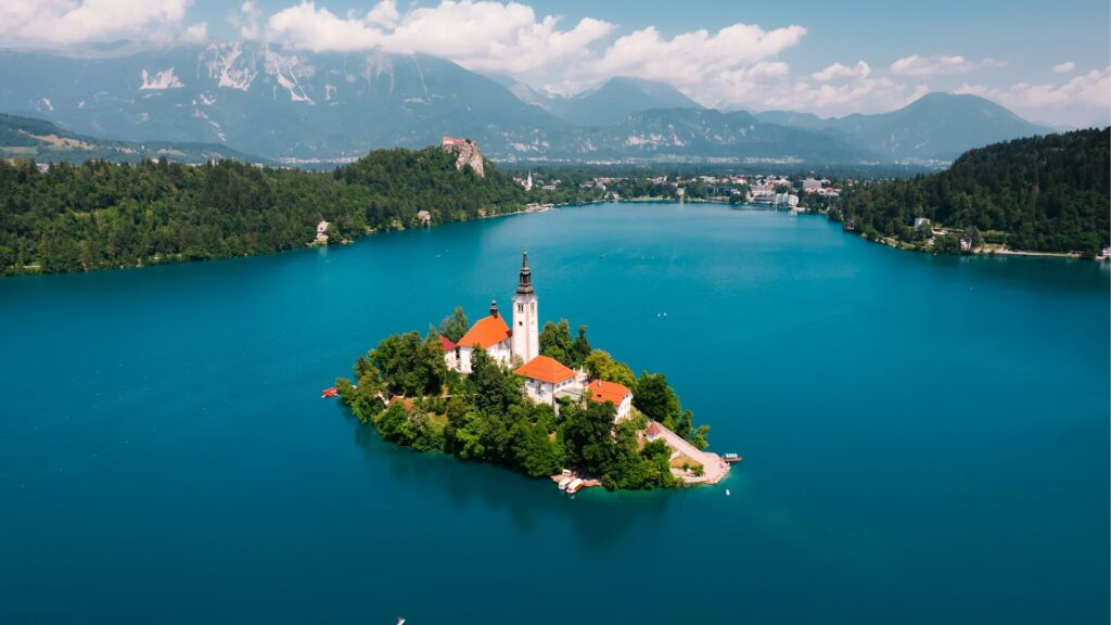 a small lake with a church on it