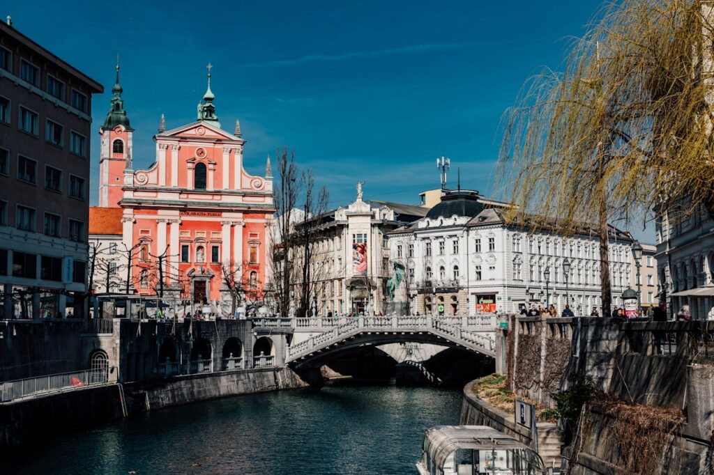 a bridge over a river with buildings and trees